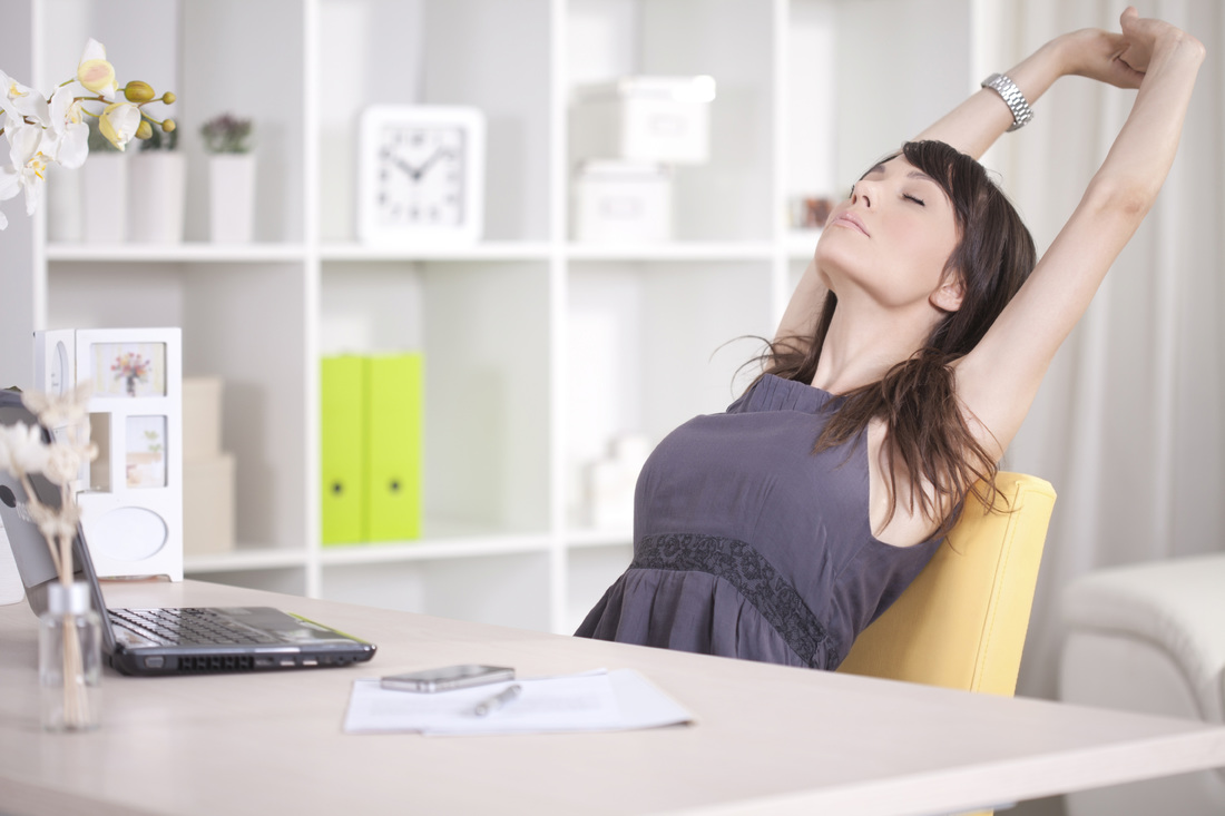 woman stretching at her desk